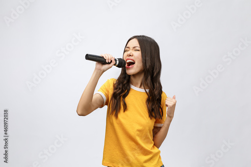 Obraz na plátně beautiful stylish woman singing karaoke isolated over white background