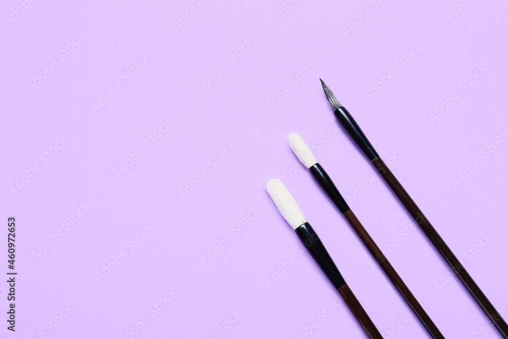 Calligraphic brushes on lilac background Calligraphic brushes on lilac background