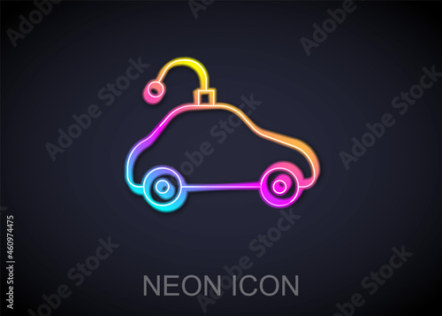 Glowing neon line Radio controlled car toy icon isolated on black background. Control remote car toy. Vector