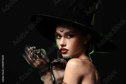 Young witch with spider on ...