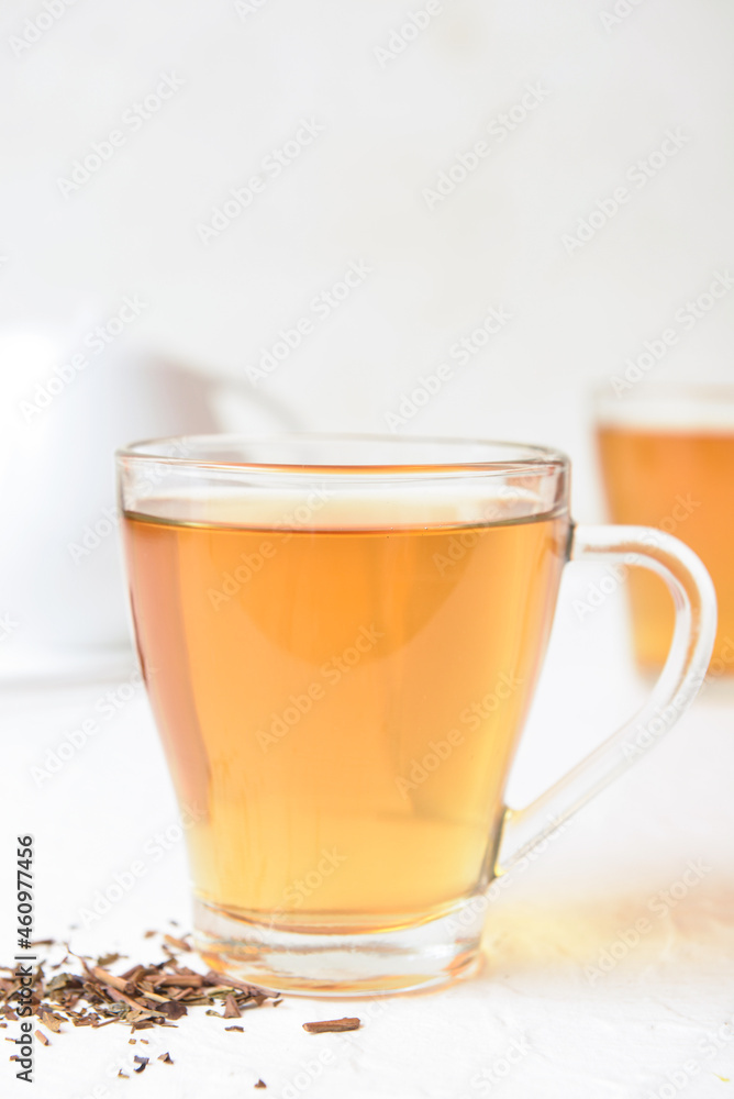 Glass cup of tasty hojicha green tea on white background Glass cup of tasty hojicha green tea on white background