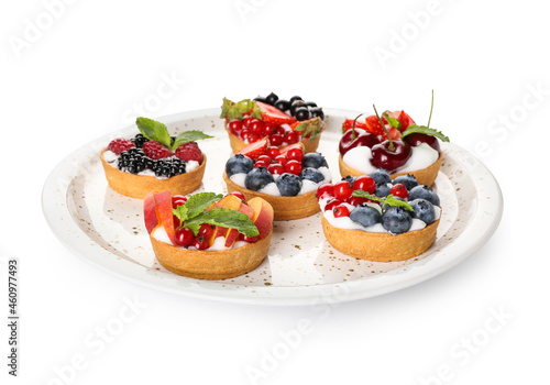 Plate with tasty berry tartlets on white background