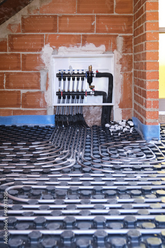 Radiant floor heating hydronic manifold with flexible tubing.