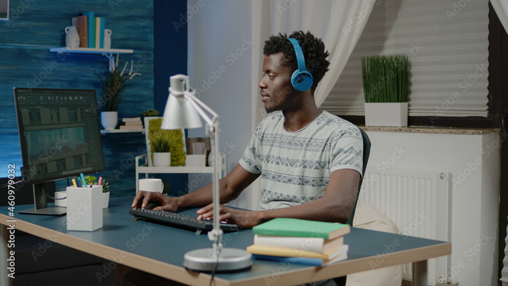 Engineer with headphones creating building model on computer. Architect working with software to design construction layout and blueprint plan for development. Architectural concept Engineer with headphones creating building model on computer. Architect working with software to design construction layout and blueprint plan for development. Architectural concept