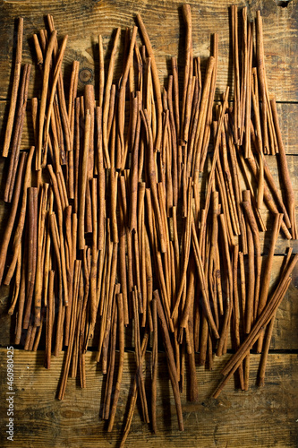 Cinnamon sticks lying on wooden surface photo
