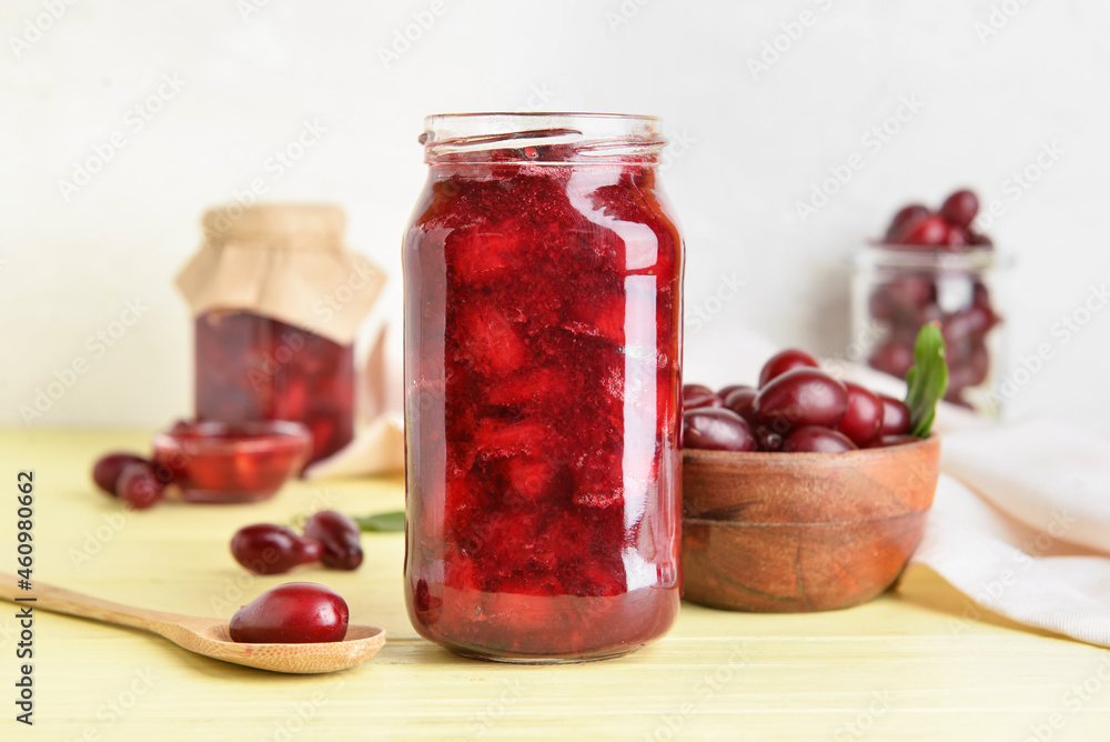 Jar of delicious dogwood jam and berries on table Jar of delicious dogwood jam and berries on table