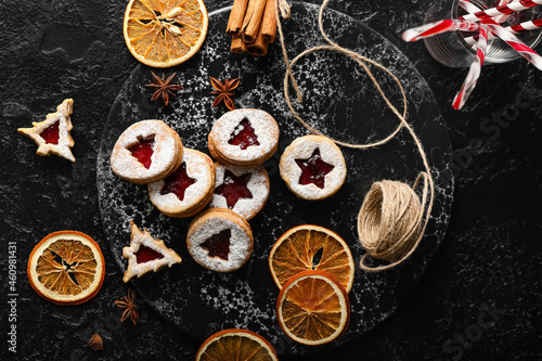 Board with tasty Linzer cookies and spices on dark background © Pixel-Shot
