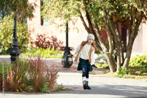 cute girl dressed in autumn clothes on a walk © Julie Boro