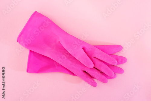 pink gloves for cleaning on a pink background