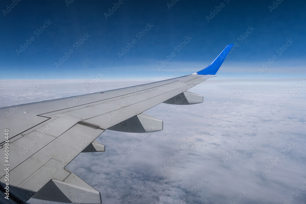 aircraft wing from the aircraft window overlooking the blue sky and beautiful clouds aircraft wing from the aircraft window overlooking the blue sky and beautiful clouds