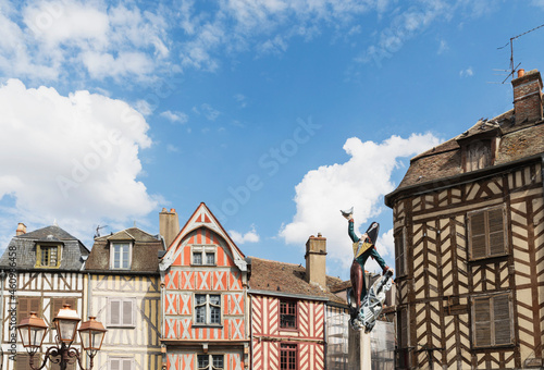 France, Yonne Department, Auxerre, Cadet Rousselle statue in front of historic half-timbered houses photo