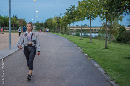 Sporty Woman. 40 Year Old Blonde Woman Walking Through A Park Doing Her Daily Exercise Routine