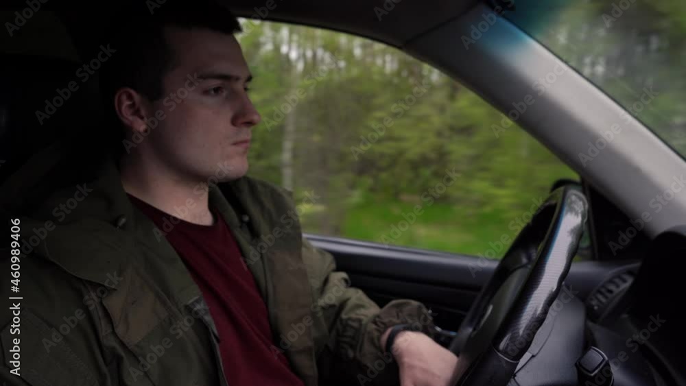 man is driving a car in the woods man is driving a car in the woods