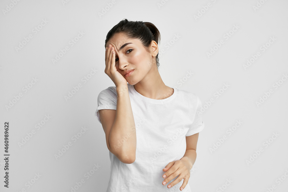 woman in white t-shirt headache health problems woman in white t-shirt headache health problems