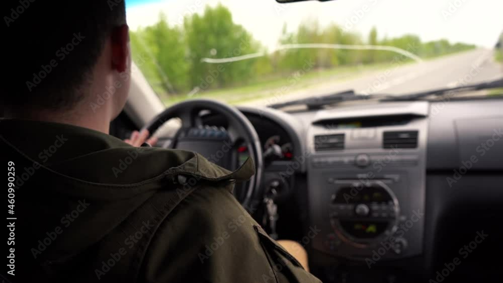 man is driving a car. rear seat view man is driving a car. rear seat view