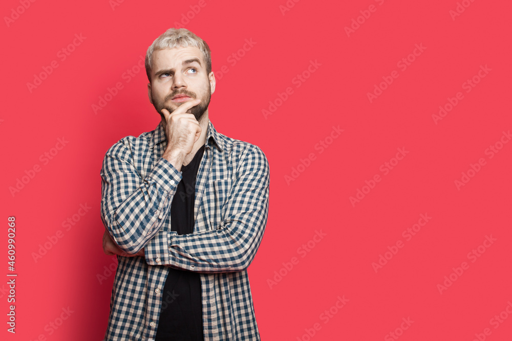 Blonde man gesturing think sign. Advertising banner. Man touching his chin while thinking.