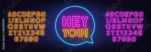Hey you neon sign on brick wall background.