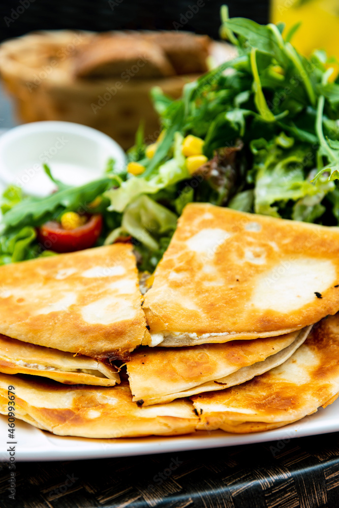 Delicious Mexican beef quesadillas with fresh lettuce and guacamole sauce Delicious Mexican beef quesadillas with fresh lettuce and guacamole sauce
