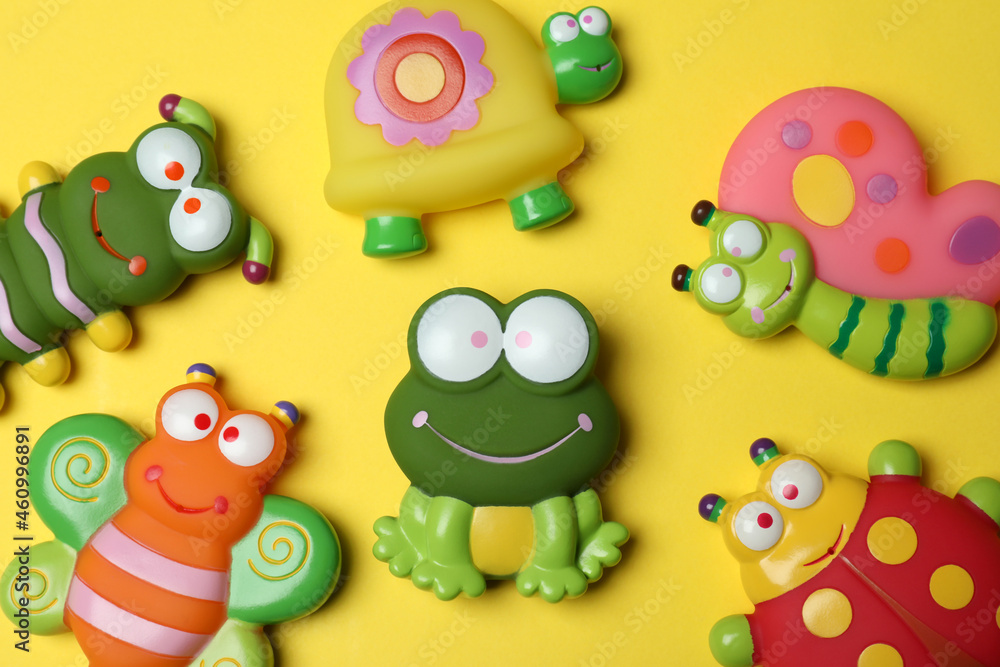Cute baby toys on yellow background, top view Cute baby toys on yellow background, top view