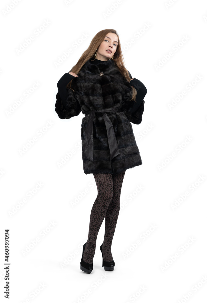 Fototapeta premium Young pretty girl posing in dark short mink fur coat, full height isolated on white background 
