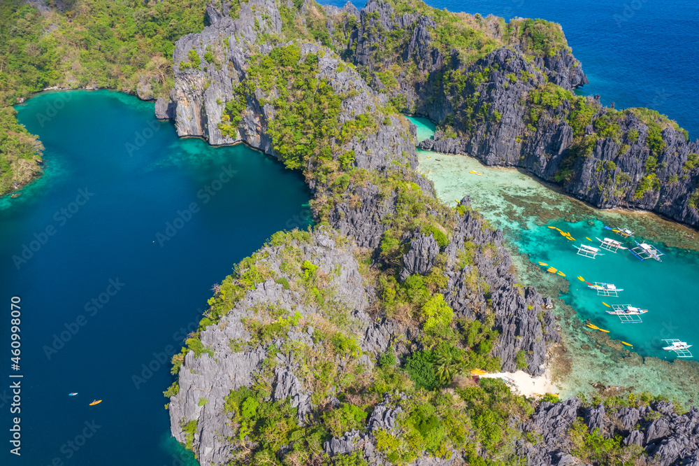 Aerial drone view azure sea and of tourist boats around the beautiful big and small lagoons in El Nido, Palawan, Philippines.