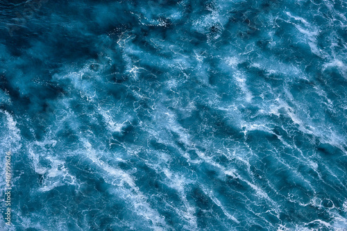 Fototapeta Naklejka Na Ścianę i Meble -  Aerial view to seething waves with foam. Waves of the sea meet each other during high tide and low tide
