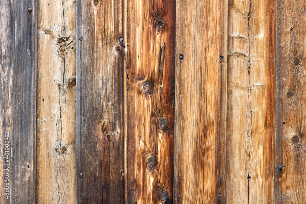 Wooden background of brown boards with visible knots Wooden background of brown boards with visible knots