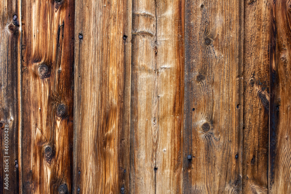Fototapeta premium Drewniane tło z brązowych desek z widocznymi sękami