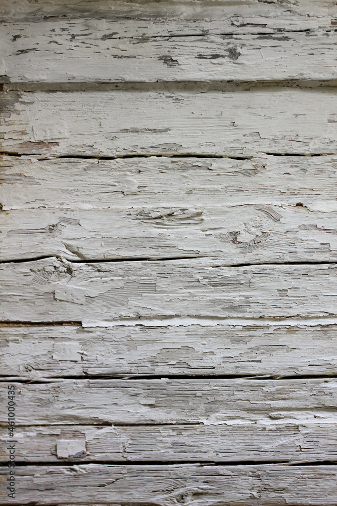 Boards covered with white, flaking paint Boards covered with white, flaking paint