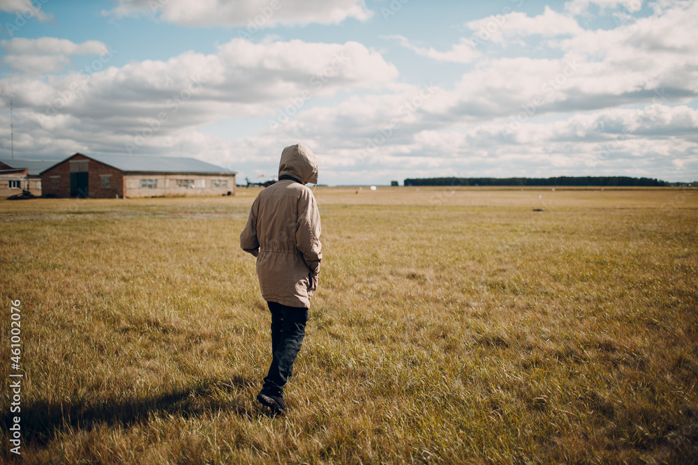 Man walking in grass field in autumn dressed. Man walking in grass field in autumn dressed.