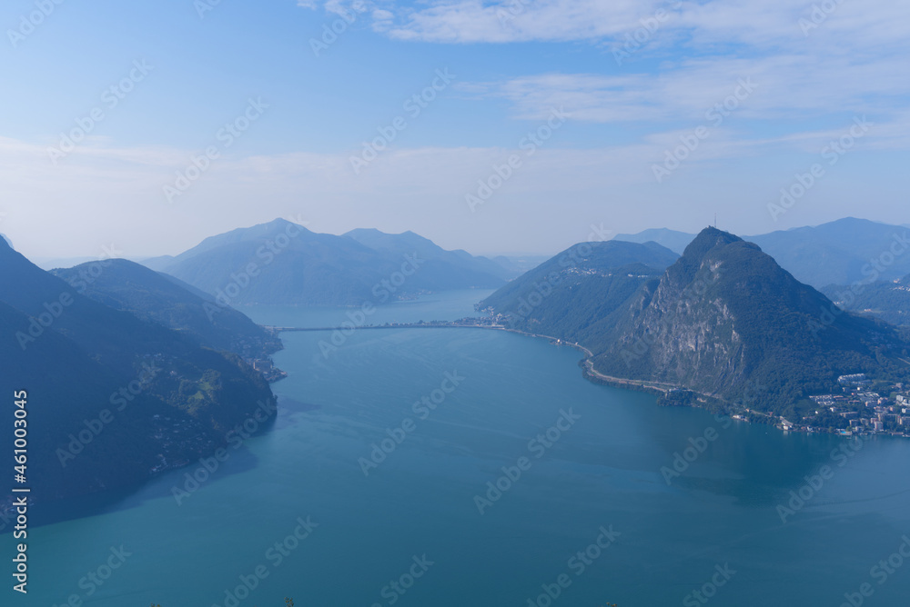 Aerial view from mountain Monte Brè over Lake Lugano and City of Lugano on a late summer day. Photo taken September 11th, 2021, Lugano, Switzerland.