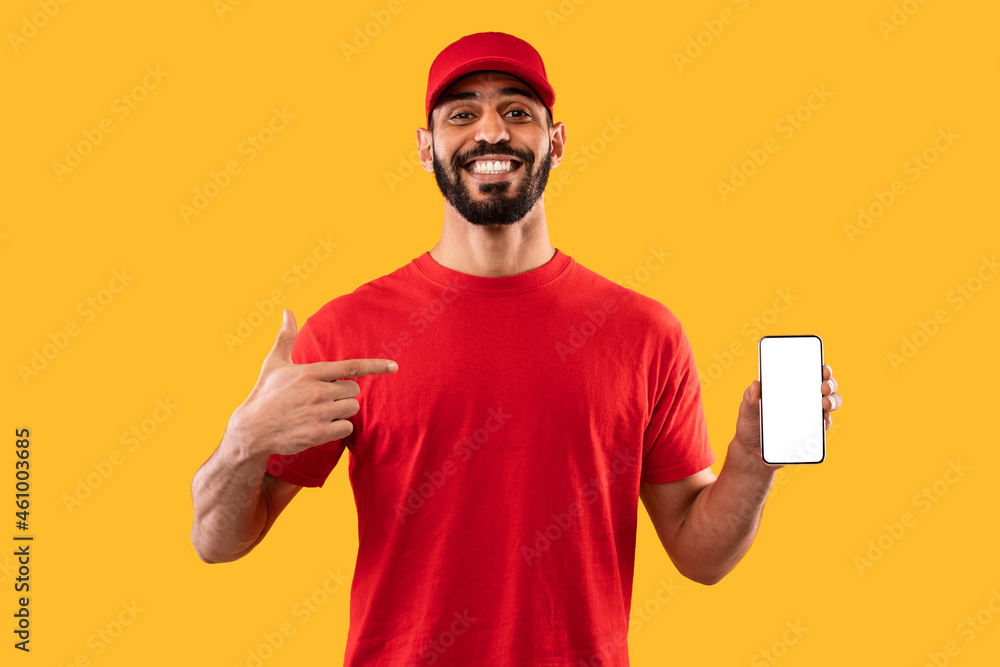 Arab Courier Guy Showing Phone With Empty Screen, Yellow Background Arab Courier Guy Showing Phone With Empty Screen, Yellow Background