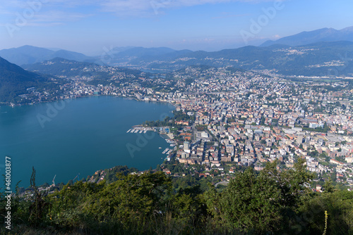 Aerial view form Mountain Monte Brè bay of Lake Lugano and City of Lugano on a sunny late summer morning. Photo taken September 11th, 2021, Lugano, Switzerland.