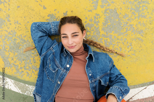 Woman with hand behind head lying on sports court photo