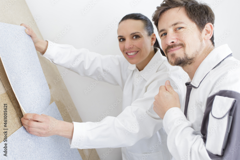 Fototapeta premium man and woman choosing wallpapers in their new apartment