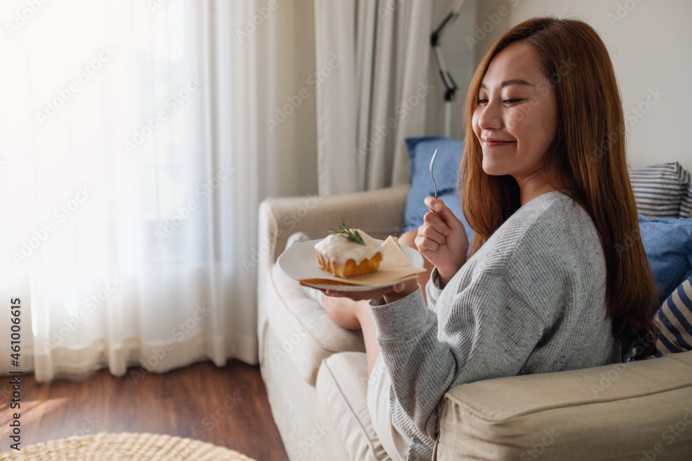 A young woman holding and eating a piece of lemon pound cake
