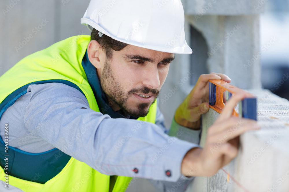 young builder holding a level young builder holding a level
