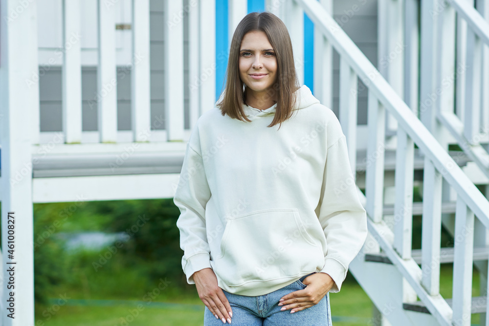 Young woman in white hoodie. Young woman in white hoodie.