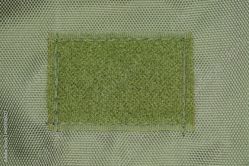 Bild auf Leinwand green fabric texture on a one rectangular sticky buckle on a backpack