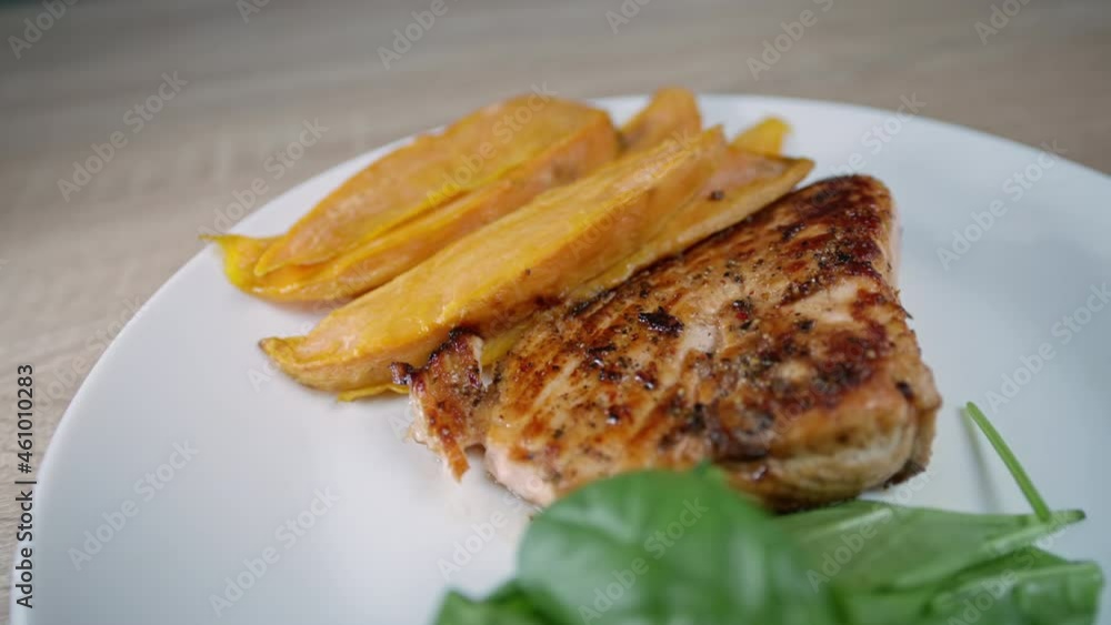 Close-up of dinner, sweet potatoes, fish and greens spinach. High quality 4k footage Close-up of dinner, sweet potatoes, fish and greens spinach. High quality 4k footage