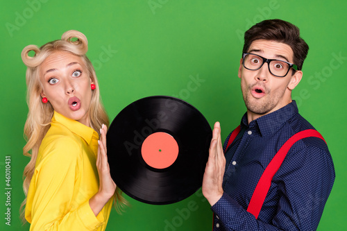 Photo of impressed funny young lady guy dressed pinup outfits holding vinyl disk isolated green color background