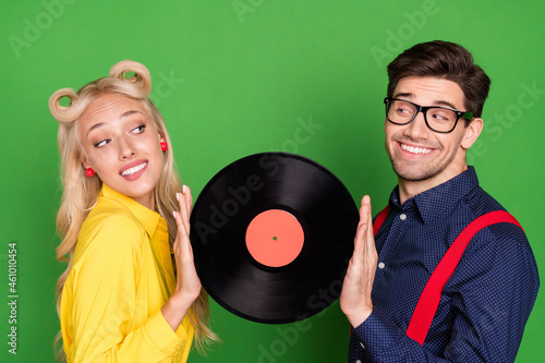 Profile side photo of young couple hold vinyl disc romantic feelings partners glamour 60s isolated over green color background