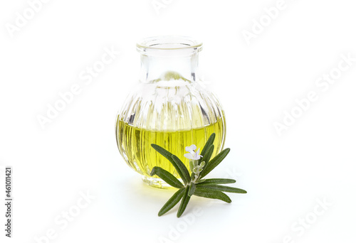 Rosemary and essential oil isolated on white background. photo