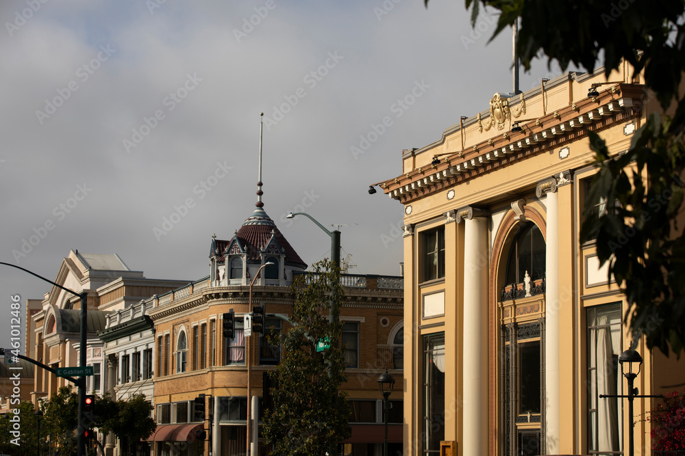 During a break in the fog, afternoon sunlight shines on the historic city center of downtown Salinas, California, USA. - obrazy, fototapety, plakaty 