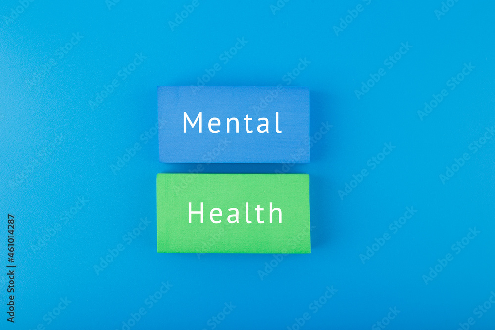 Mental health text written on colorful blocks on dark blue background Mental health text written on colorful blocks on dark blue background