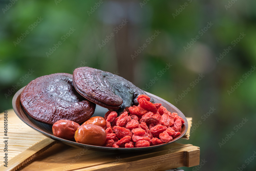 Reishi or lingzhi mushroom ,goji berry and red jujube on nature background. Reishi or lingzhi mushroom ,goji berry and red jujube on nature background.