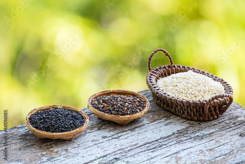 Black red and white sesame seeds on bokeh nature background. photo