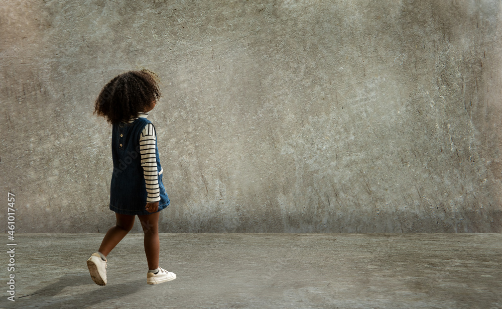 Girl turning back in an empty cement room. Girl turning back in an empty cement room.