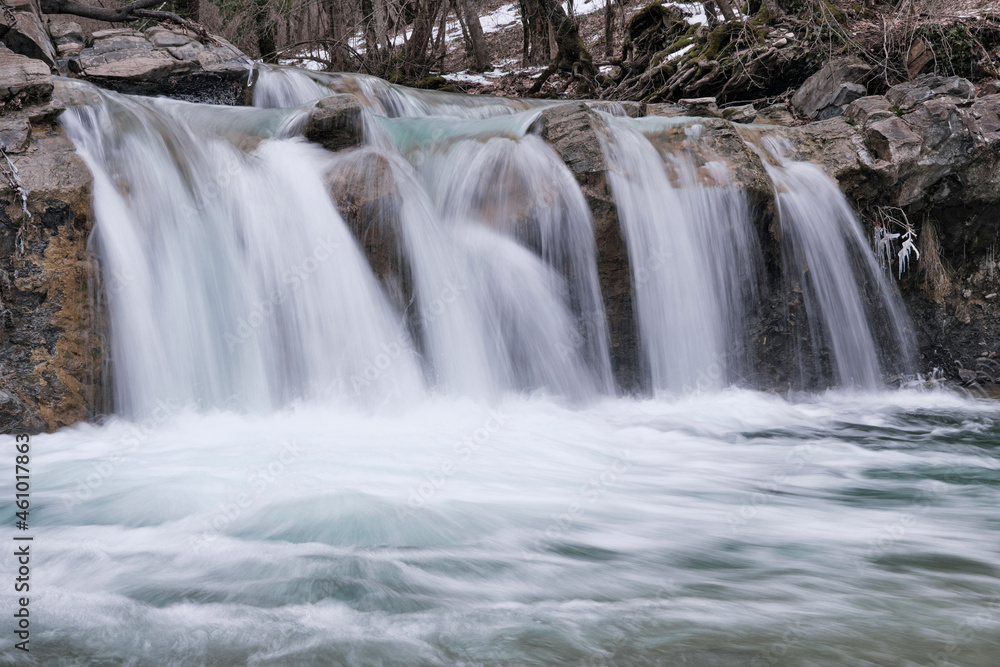 Fototapeta premium View of waterfall on Zhane river on cloudy winter day. Krasnodar Krai, Caucasus, Russia.