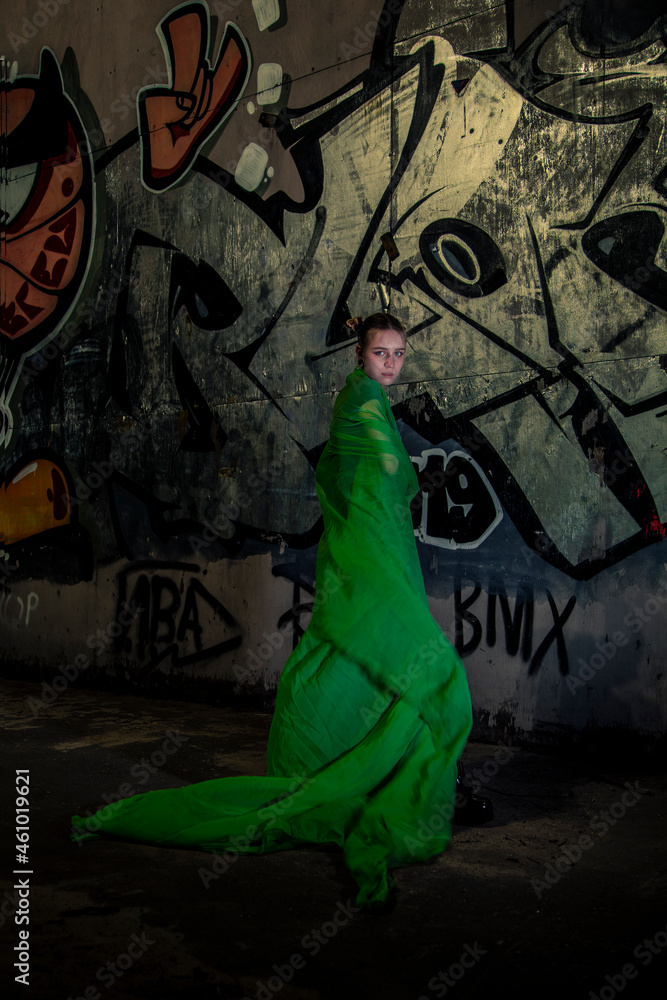 Girl posing in green draping on dark background Girl posing in green draping on dark background